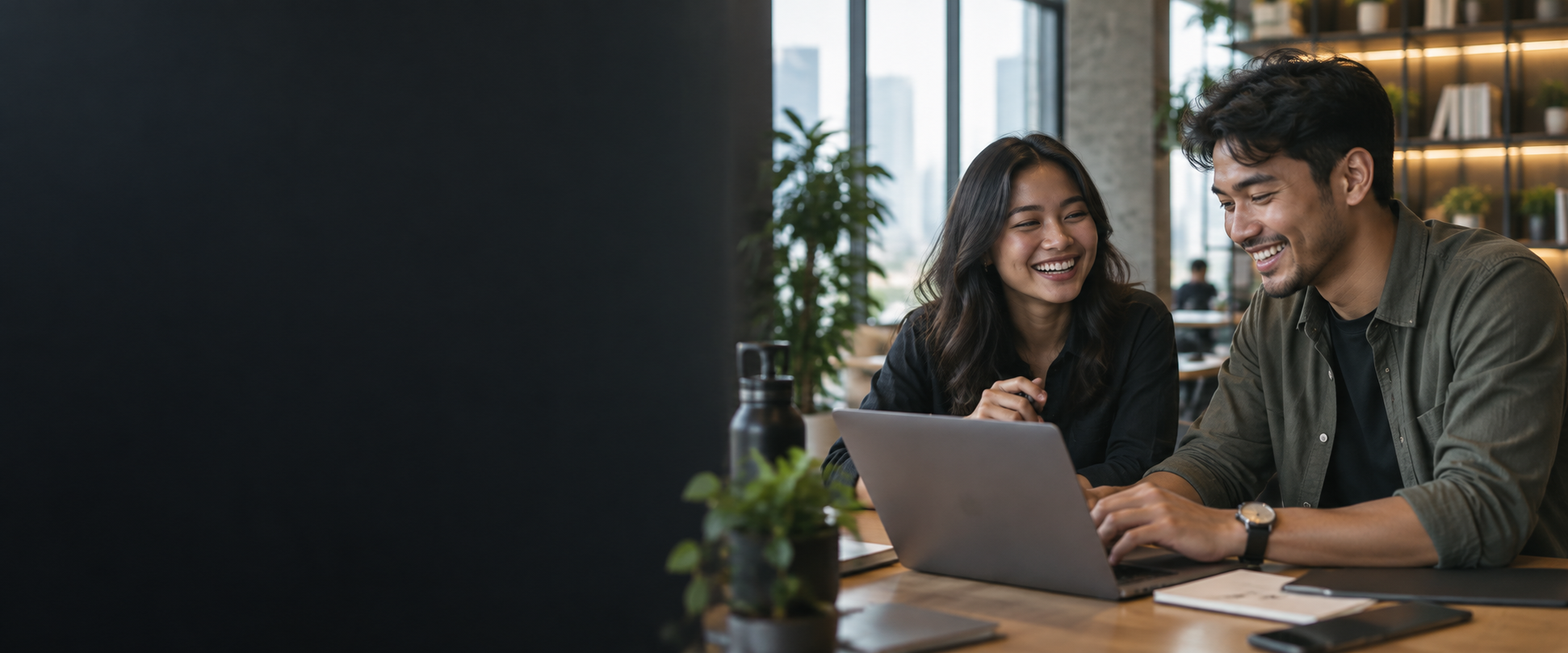Two colleagues collaborating at a laptop